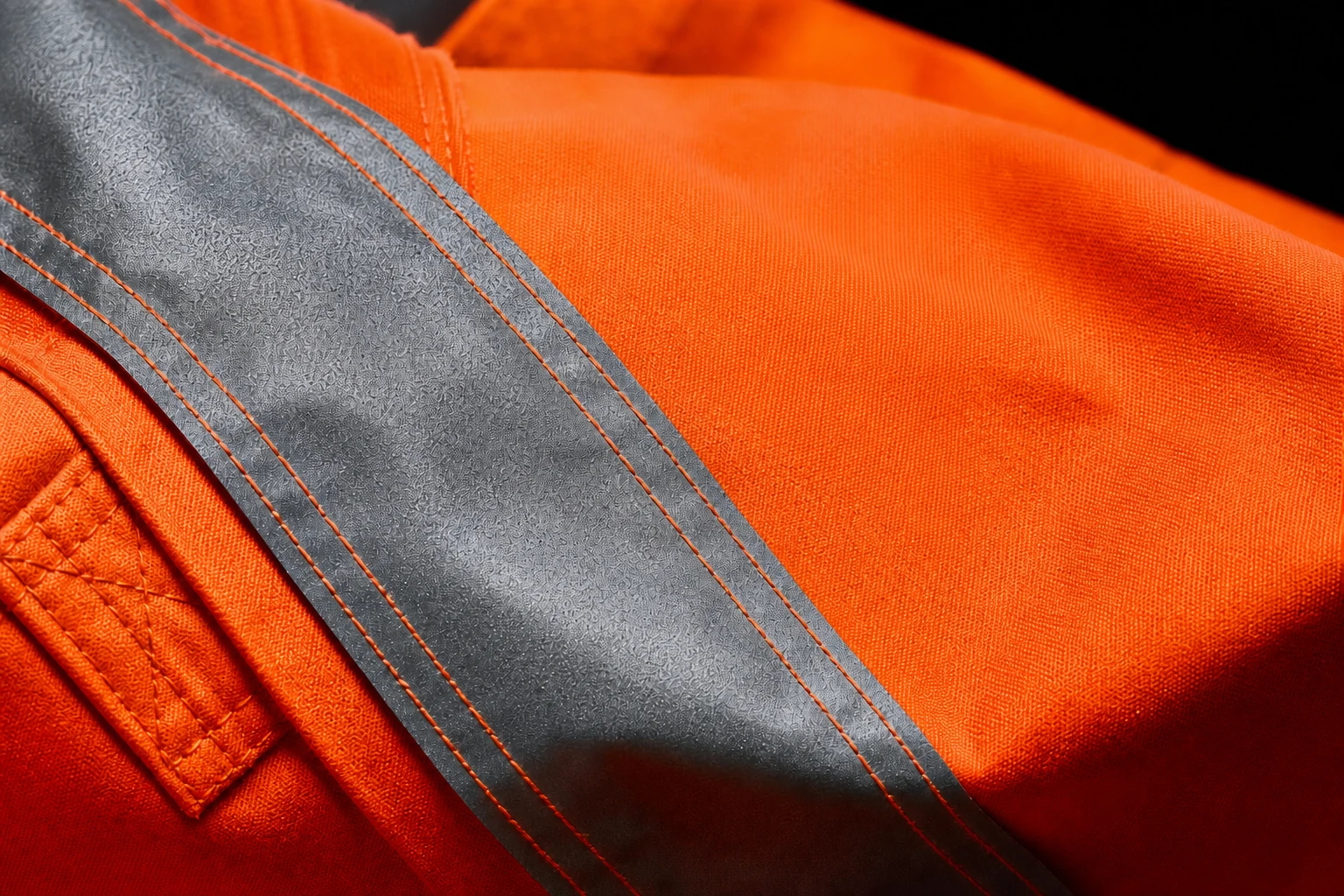 Close-up of the official 3A Print logo beside reflective tape on orange high-vis workwear