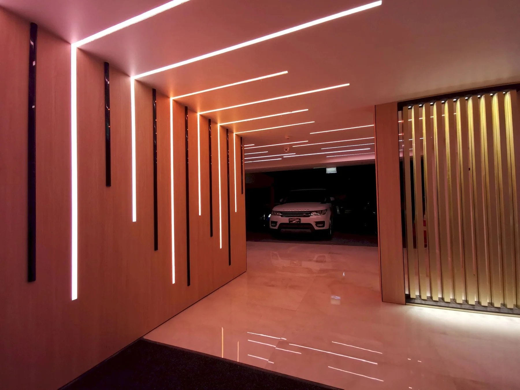 Architectural lighting and timber wall details in a renovated Auckland vehicle showroom