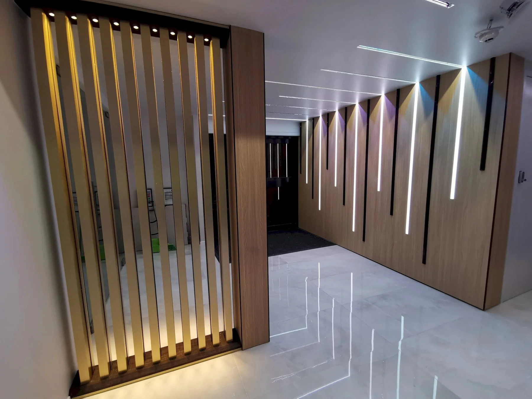Illuminated timber feature wall and polished floor in an Auckland commercial fit-out